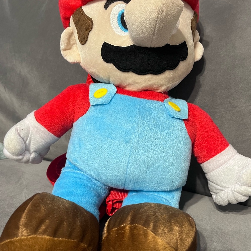 Super Mario Plush Backpack with zipper compartment in the back.